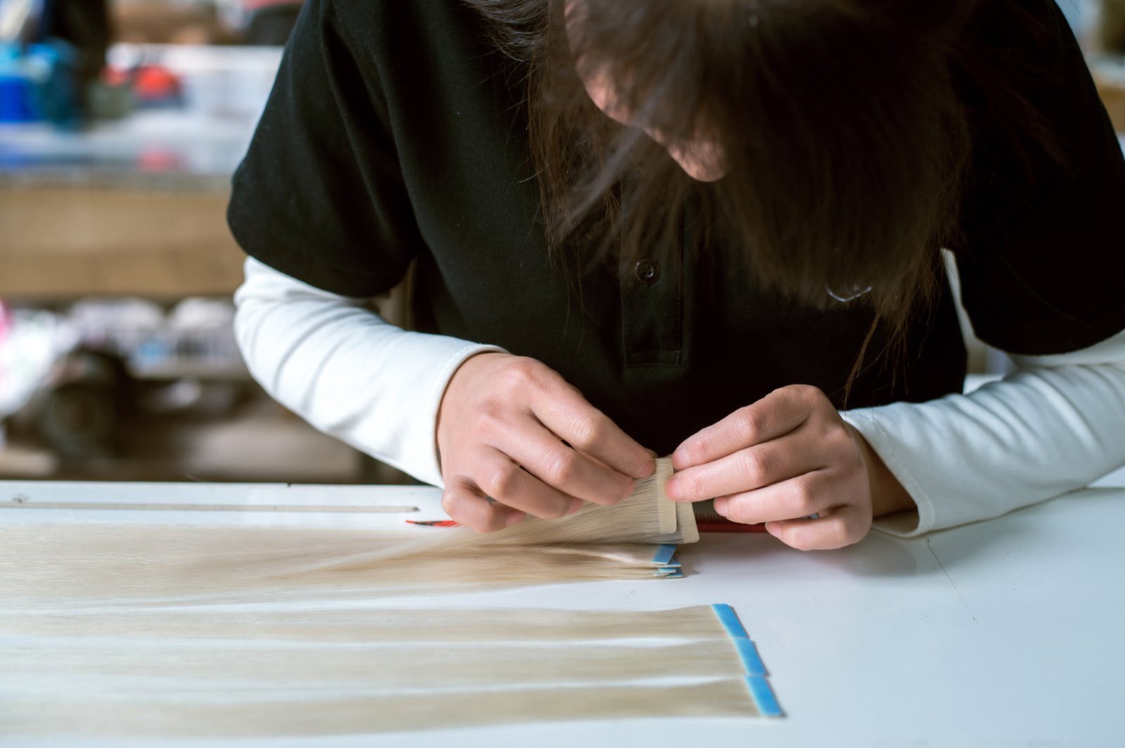 Epoche Hair factory floor with skilled artisans crafting premium hair extensions