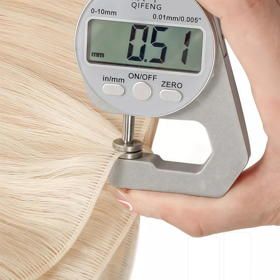 Digital gauge measuring the thickness of an Epoche human hair weft for construction control