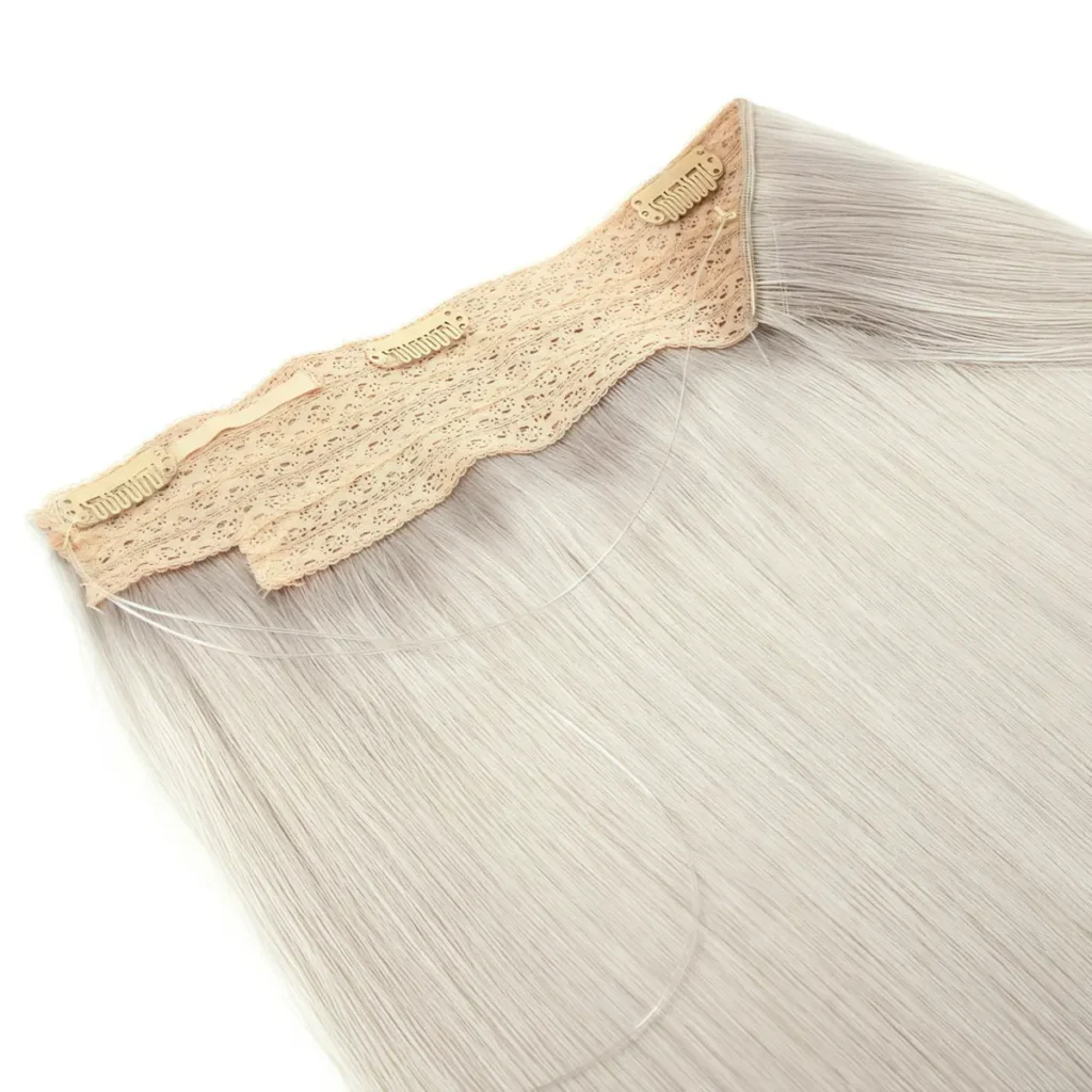 Blonde halo hair extensions with a beige lace band, snap clips and a transparent support wire on a white background.