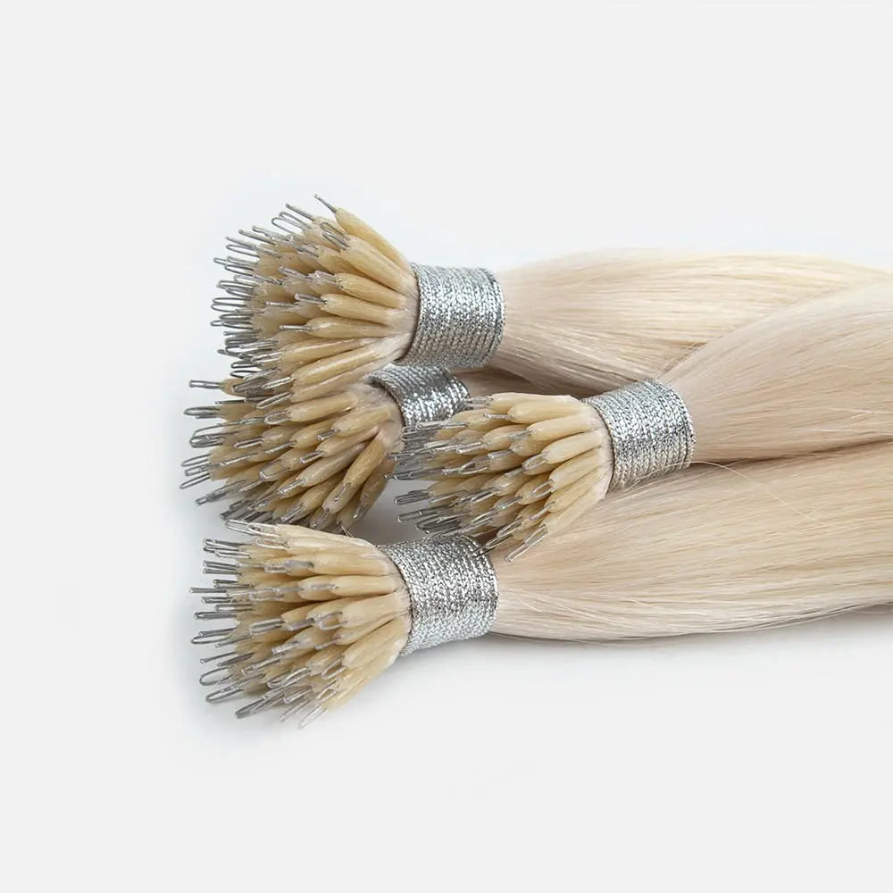 Close-up of four light blonde micro ring tip hair extension bundles with silver ties, showing the small metal loops extending from the bonds.