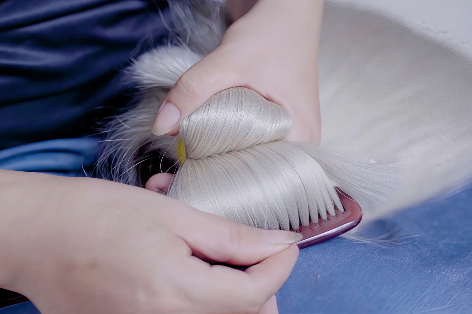 Human hair being manually prepared and sorted during extension production