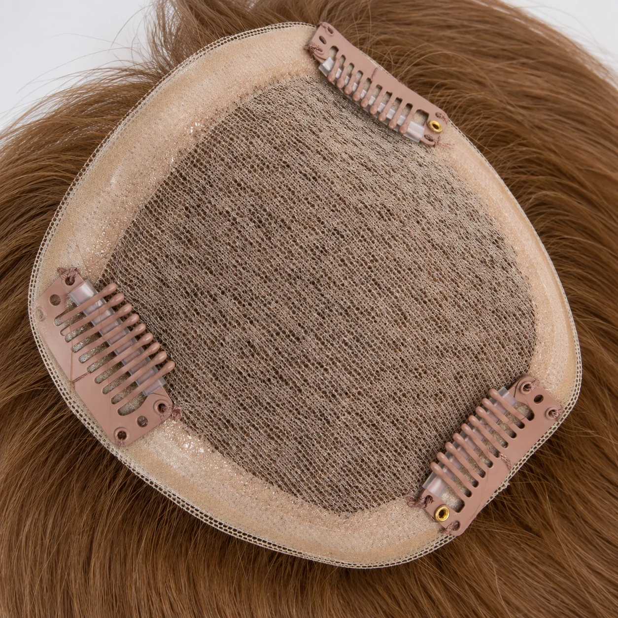 Hair Topper Mesh Base and Clip Detail | Epoche Hair Underside of a brown human hair topper showing a pale mesh base, translucent edging and three pink-brown snap clips.